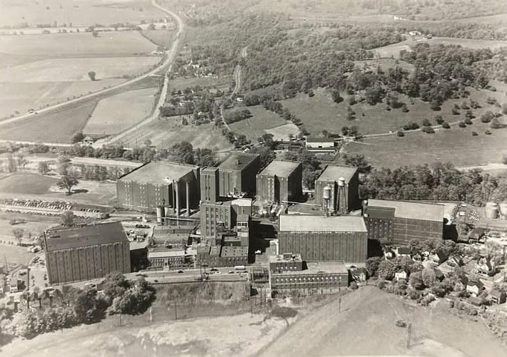 Aerial photograph of the Seagram distillery in Lawrenceburg, Indiana, around 1950, with brick warehouses beside Tanner's Creek